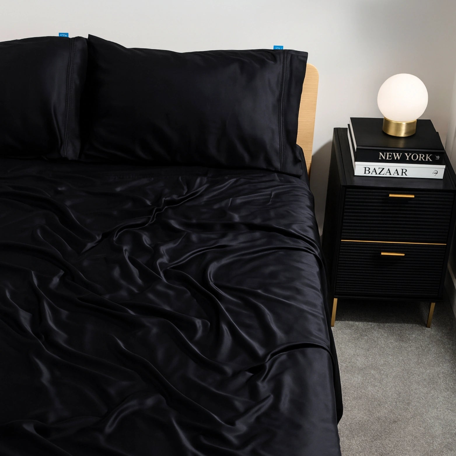 Black charcoal eucalyptus bamboo bed sheets styled on a modern bed. Luxurious, cooling bedding for hot sleepers seeking comfort and elegance.