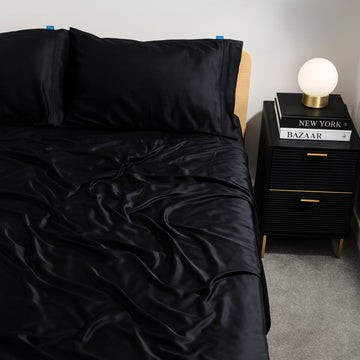 Black charcoal eucalyptus bamboo bed sheets styled on a modern bed. Luxurious, cooling bedding for hot sleepers seeking comfort and elegance.