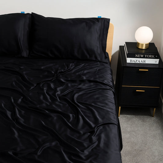 Black charcoal eucalyptus bamboo bed sheets styled on a modern bed. Luxurious, cooling bedding for hot sleepers seeking comfort and elegance.